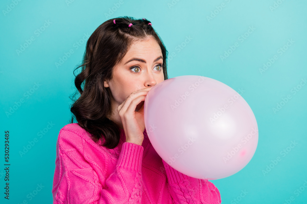 Closeup side profile photo of young attractive cute woman blow air balloon celebrating prepare isolated on cyan color background Closeup side profile photo of young attractive cute woman blow air balloon celebrating prepare isolated on cyan color background