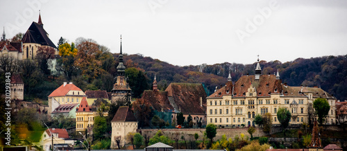 Ancient Sighisoara city in Romania, panoramic old clock tower, castle and medieval architecture view. Historic european town with heritage and Dracula house