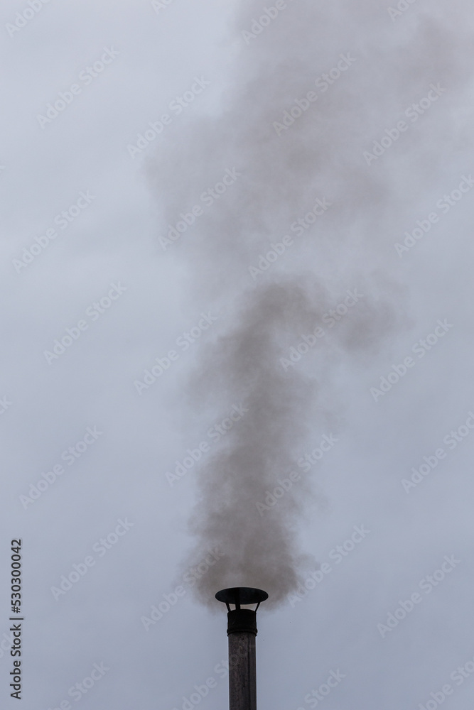 smoke from a chimney against the sky