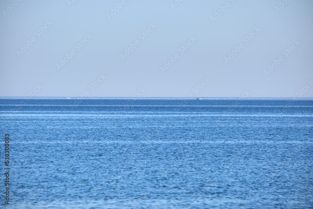 Closeup seascape surface of blue sea water with small ripple waves Closeup seascape surface of blue sea water with small ripple waves