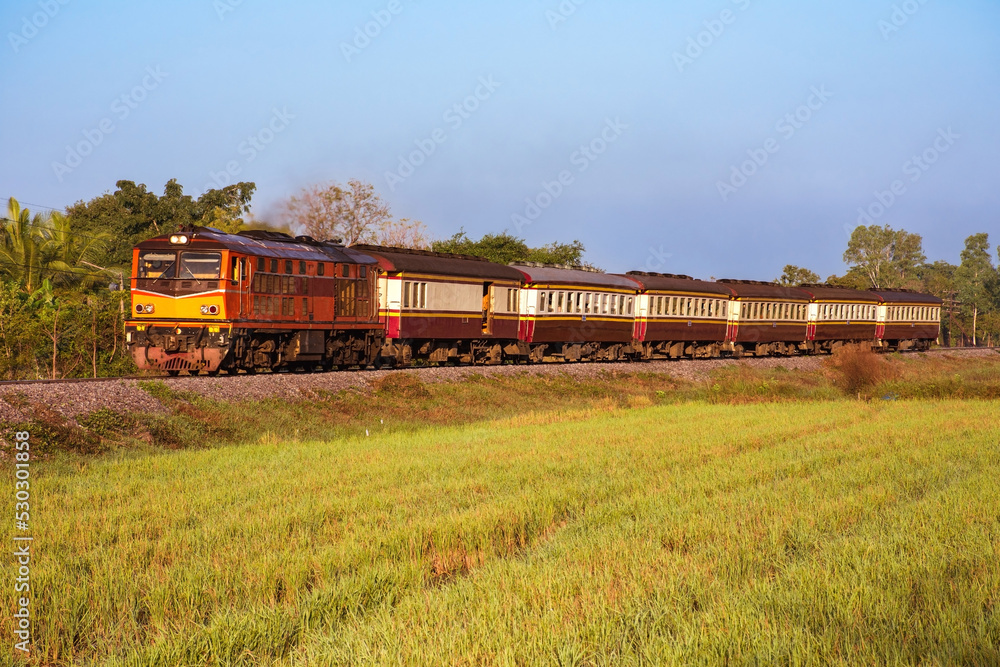 Passenger train by diesel locomotive on the railway.