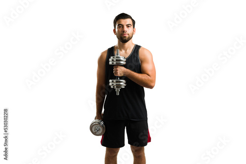 Handsome latin man lifting dumbbell weights