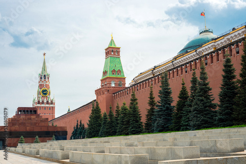 Moscow Kremlin wall with the Spasskaya Tower and Lenin's Mausoleum on Red Square in summer day. photo