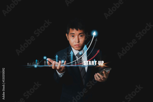 Startup business and network connection. Businessman startup business from smartphone. photo