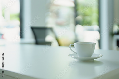 A cup of hot coffee is ready to drink on the desk
