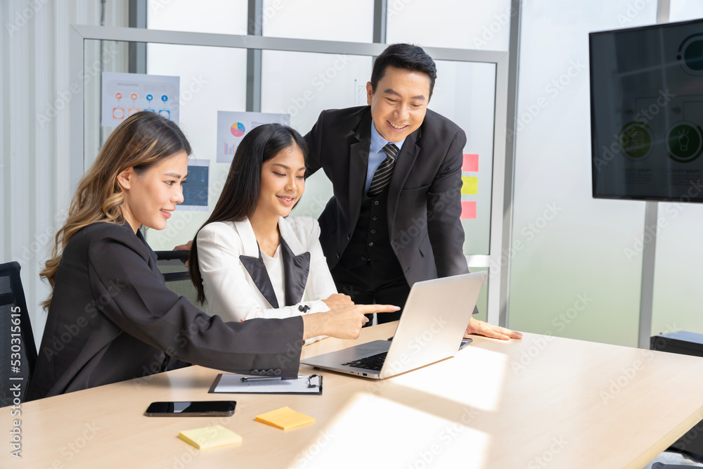A group of young Asian businessmen Talking and planning work happily and have fun at the company's office
