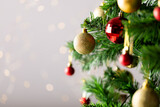 Image of christmas tree with baubles decoration and copy space on grey background