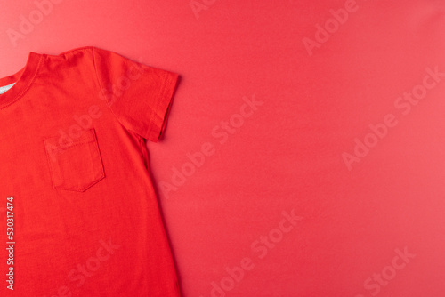 Image of red tshirt lying on red surface