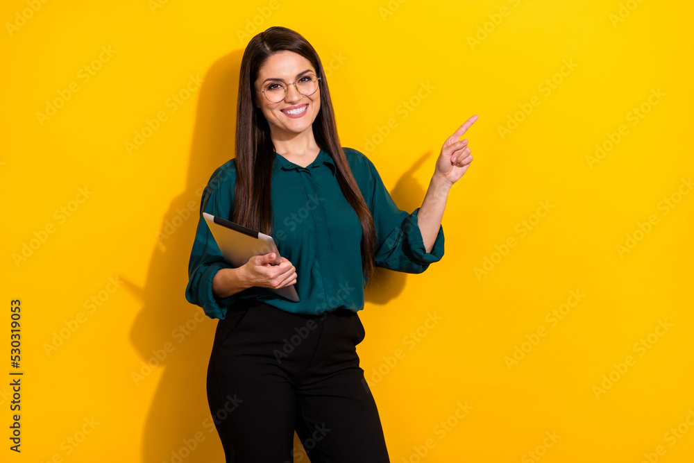 Photo of confident pretty lady dressed green shirt glasses chatting modern gadget empty space isolated yellow color background Photo of confident pretty lady dressed green shirt glasses chatting modern gadget empty space isolated yellow color background
