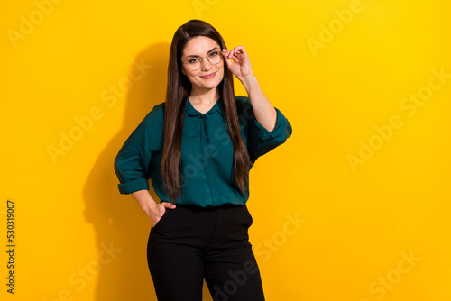 Photo of smart clever lady dressed green shirt arm glasses smiling empty space isolated yellow color background