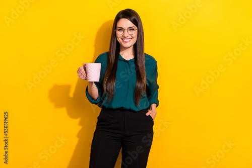 Photo of young pretty cheerful woman drink cappuccino americano rest isolated over yellow color background