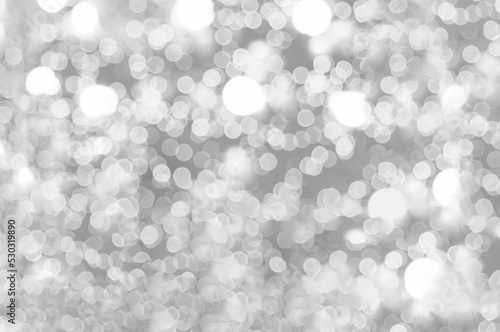 Blurred background silver glitter shiny sparkling banner. Happy Holidays background for white template on christmas card brochure. Silver bokeh template for digital presentation slideshow background
