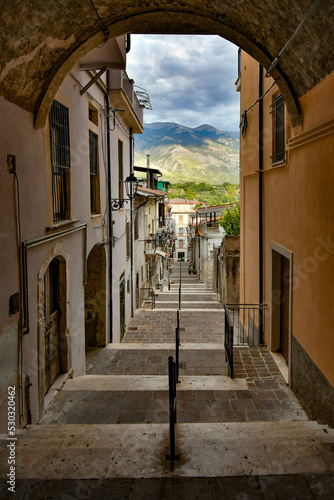 A narrow street between the old stone houses of Pratola Peligna, a medieval village in the Abruzzo region of Italy. photo