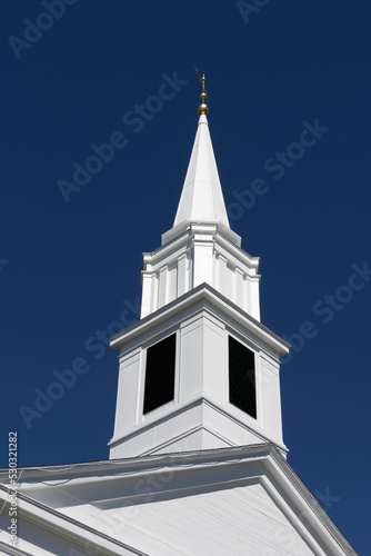 Canvas Print white church steeple against dark blue sky