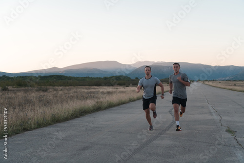 group of young sporty people jogging on a sunny morning in the city.