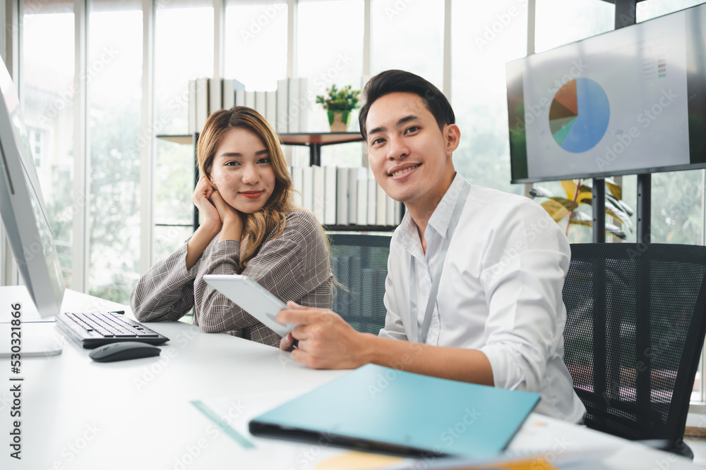 Successful team of new business startup people working together in creative office, happy euphoric proud Asian male and female professional winner feel overjoyed Successful team of new business startup people working together in creative office, happy euphoric proud Asian male and female professional winner feel overjoyed
