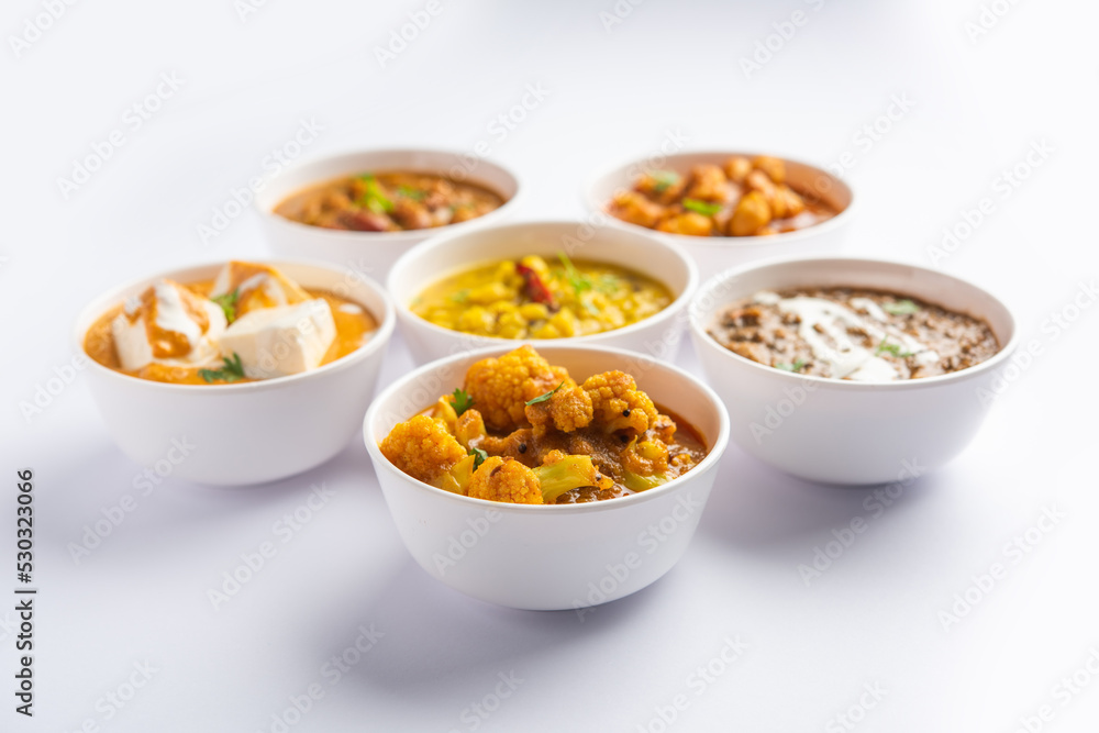 Group of Indian vegetarian dishes, hot and spicy Punjabi cuisine meal assortment in bowls Group of Indian vegetarian dishes, hot and spicy Punjabi cuisine meal assortment in bowls