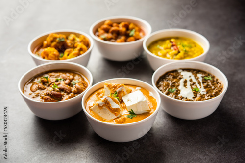 Group of Indian vegetarian dishes, hot and spicy Punjabi cuisine meal assortment in bowls