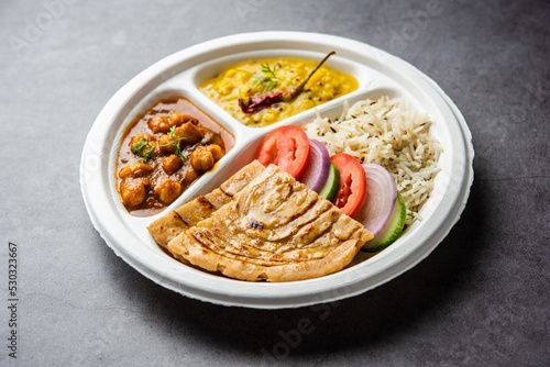 Obraz na plátně Indian mini meal parcel platter, combo thali with chole Masala, roti, dal tarka,