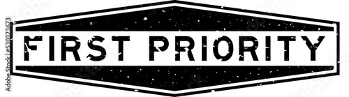 Grunge black first priority word hexagon rubber seal stamp on white background