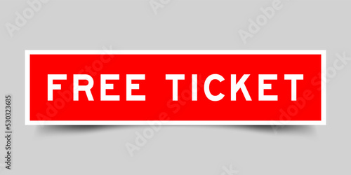 Sticker label with word free ticket in red color on gray background
