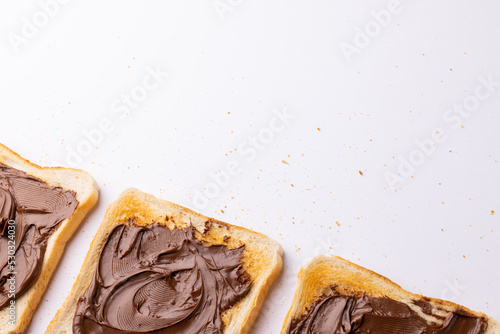 Image of bread slices with cream chocolate on white background