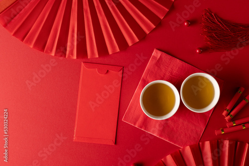 Composition of traditional chinese decorations and fans on red background