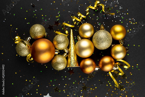 Composition of close up of new years decorations and confetti on black background
