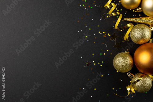 Composition of close up of new years decorations on black background