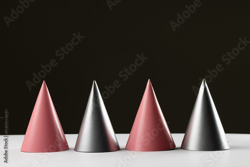 Composition of close up of new years hats on black background