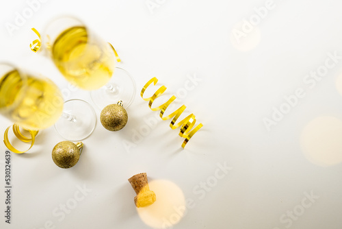 Composition of close up of new years champagne and decorations on white background