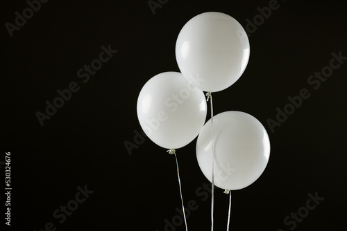Composition of close up of new years balloons on black background