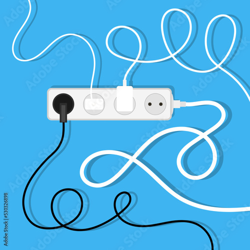 Electrical wires and chargers on blue background. A mess of cables from several extension cords. Cable management.