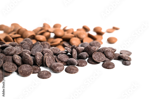 Close up of dark and milk couverture chocolate. Chocolate callets isolated on white. Chocolate making concept photo