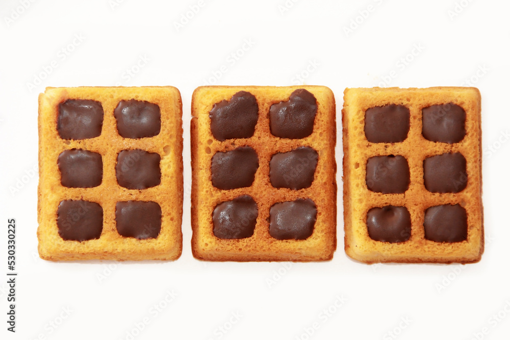 sweet baked fluted Belgian waffles with chocolate filling on a white background sweet baked fluted Belgian waffles with chocolate filling on a white background