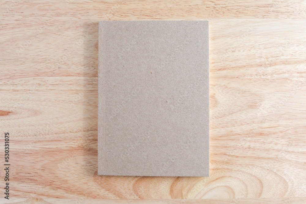 Recycled paper book on wooden background Recycled paper book on wooden background