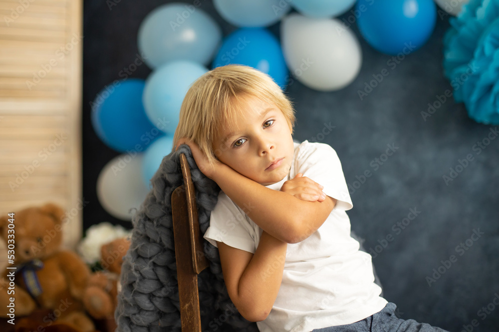 Cute preschool boy, playing with airplane, balloons and birthday decoration Cute preschool boy, playing with airplane, balloons and birthday decoration