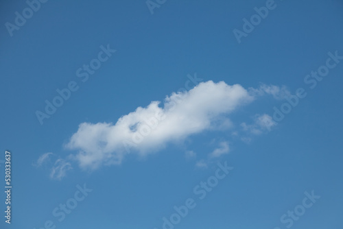 A small white cloud against a blue sky