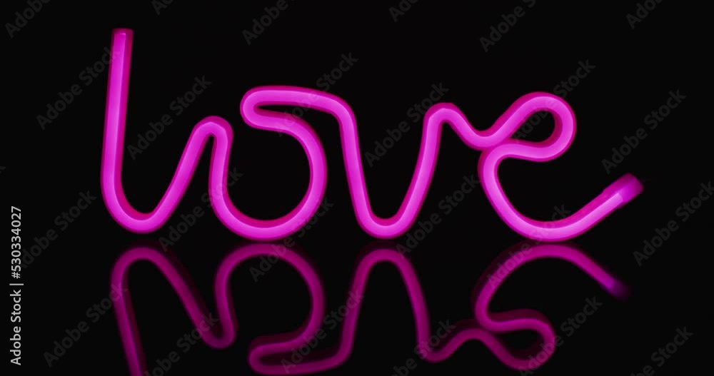 Animation of pink neon lights forming love text over black background Animation of pink neon lights forming love text over black background