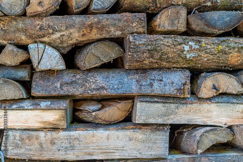 Texture of logs, firewood stacked in an old house in the Pyrenees
