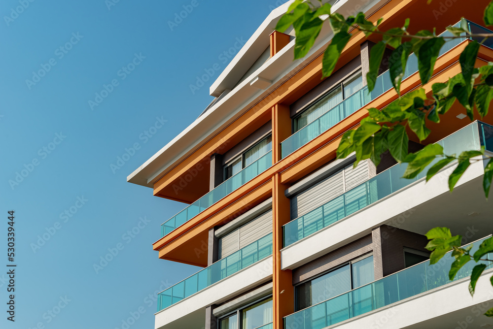 Image of the exterior of a residential building against a blue sky.