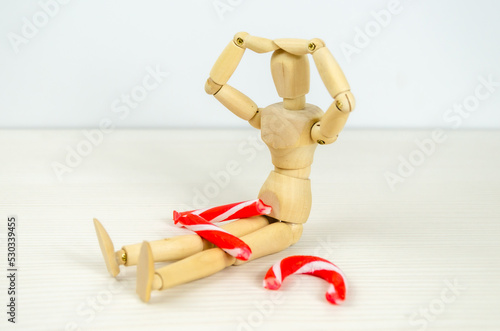 man bent over broken Candy cane in despair. Preparation for Christmas, stress, frustration, failure
