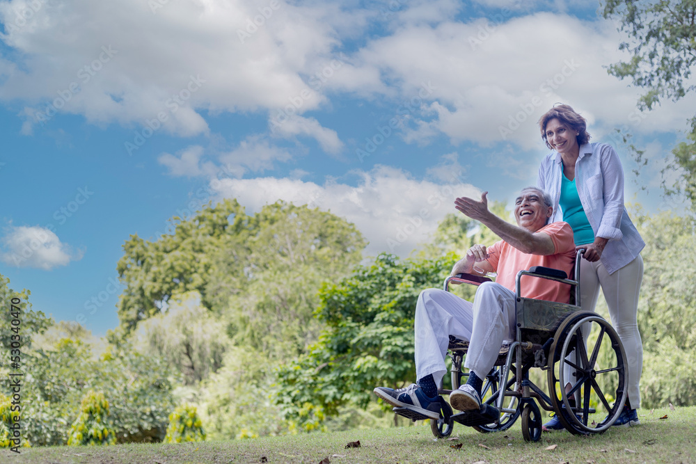 physically challenged man on wheel chair with woman physically challenged man on wheel chair with woman