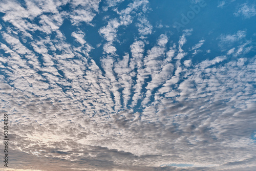 Amazing altocumulus clouds in form of ridges on blue sky. photo