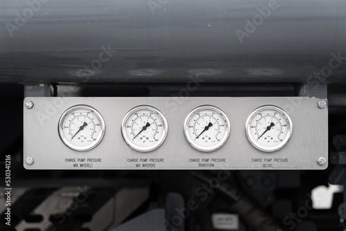 Pressure gauges panel of the power generator and fuel pumping machine. Industrial equipment object photo.