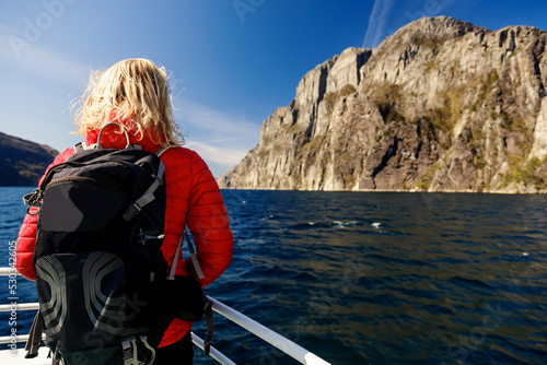 Young woman relaxing on tourist boat Norwegian fjord