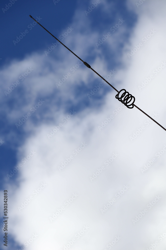 old metal spiral antenna on sky background old metal spiral antenna on sky background