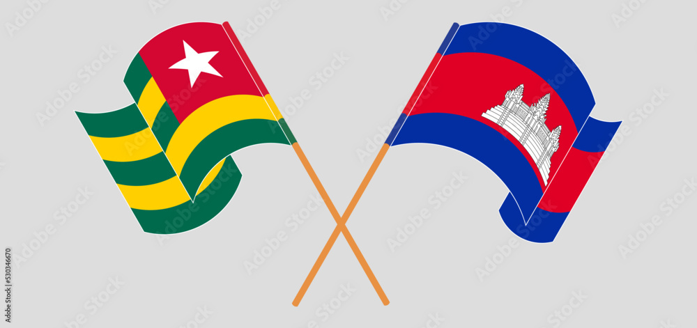 Crossed and waving flags of Togo and Cambodia