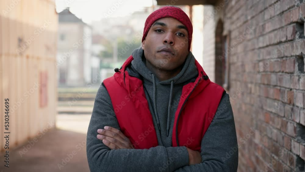 Portrait of young african american man in back street. Portrait of young african american man in back street.