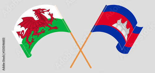Crossed and waving flags of Wales and Cambodia